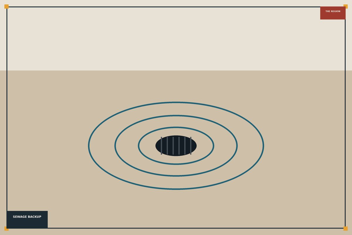 Basement floor drain backing up with dark sewer water in a Hammond home